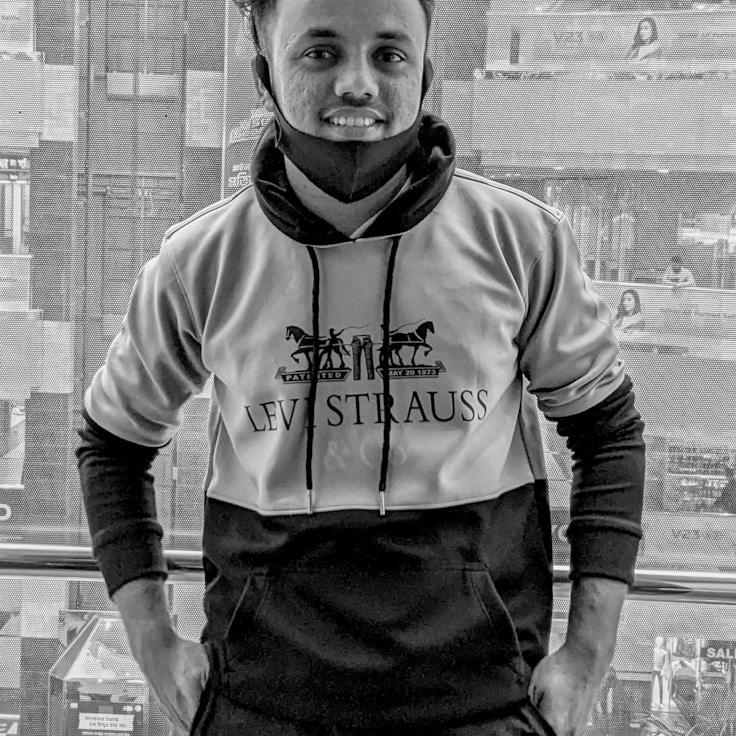 Kaveri Mehta, Lead Design Curator at SourceStudioHaven, reviewing corporate floral arrangements